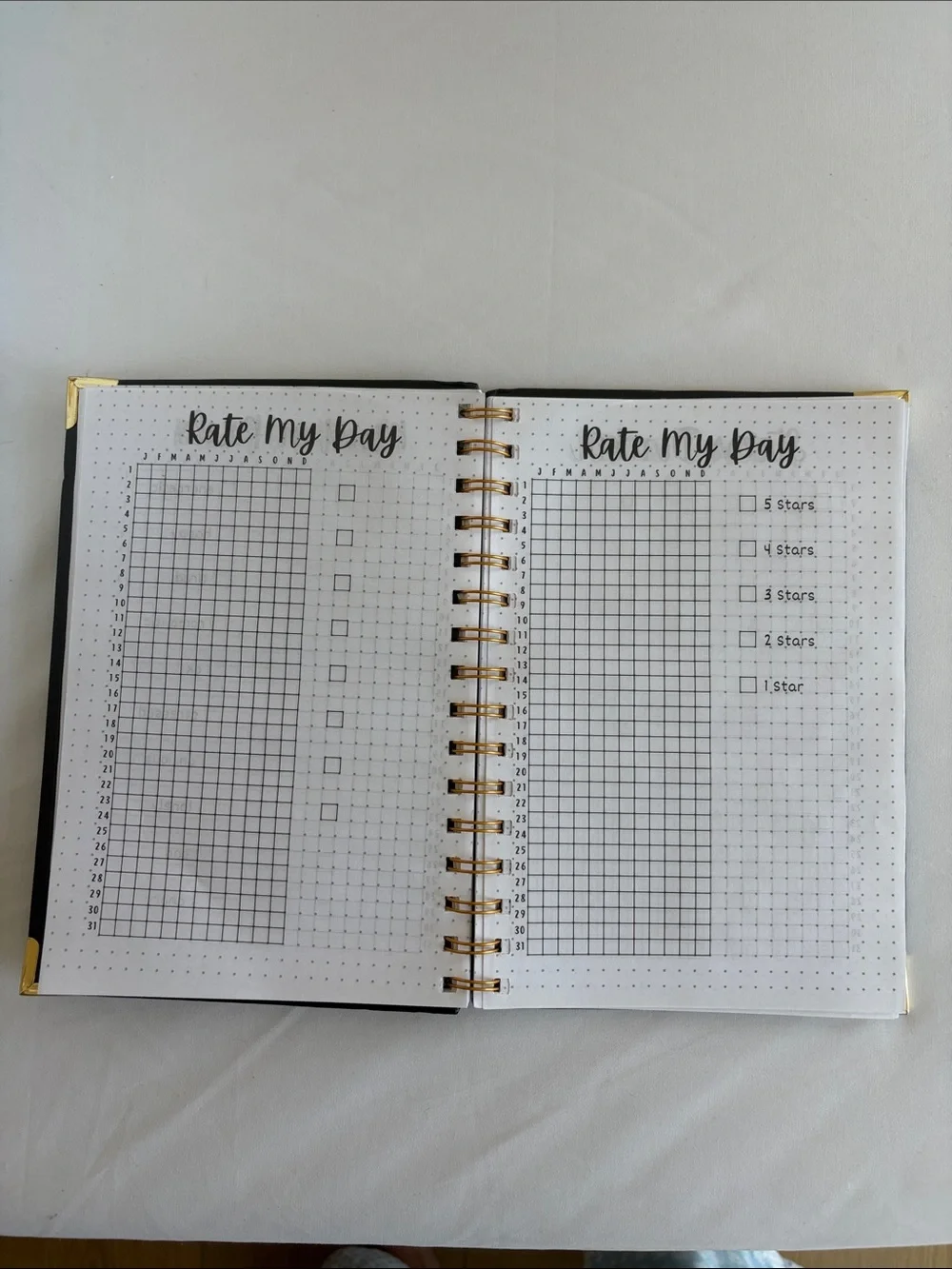 Bullet Journal Game Spiral Notebook in Black with Colored Pencils